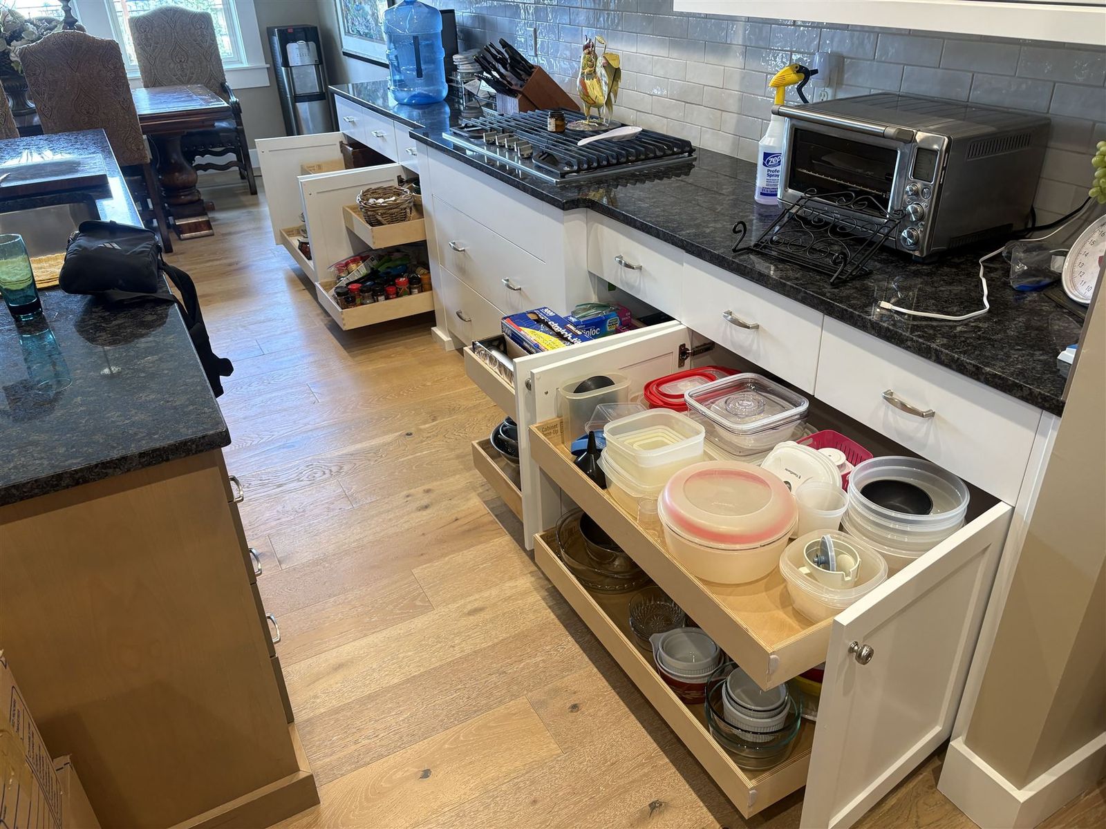 Pull-out shelves loaded with containers and cookware, every item visible at once